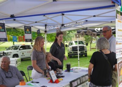 Foundation board members talking to a couple about the taco wars event.